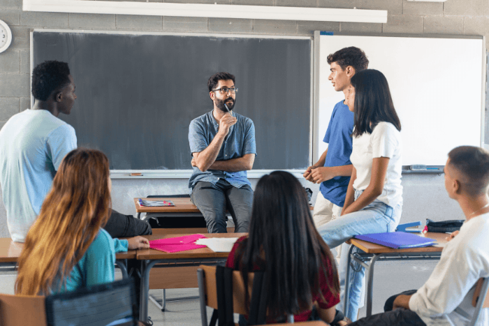 Teacher speaking with a classroom of high school students